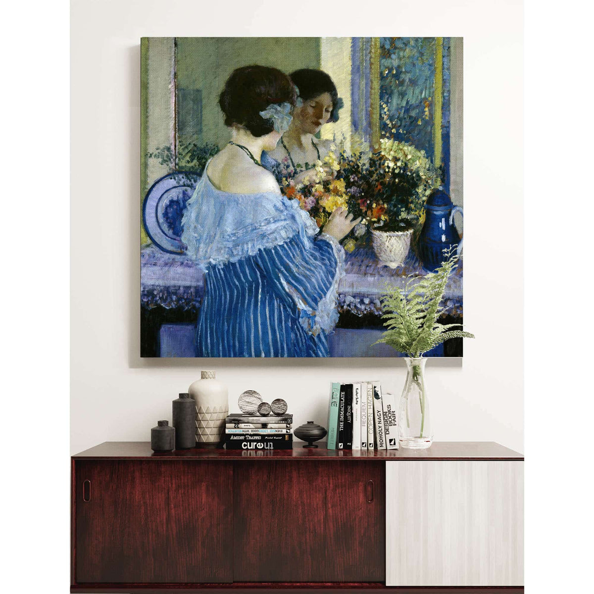 Girl In Blue Arranging Flowers by Frederick Carl Frieseke
