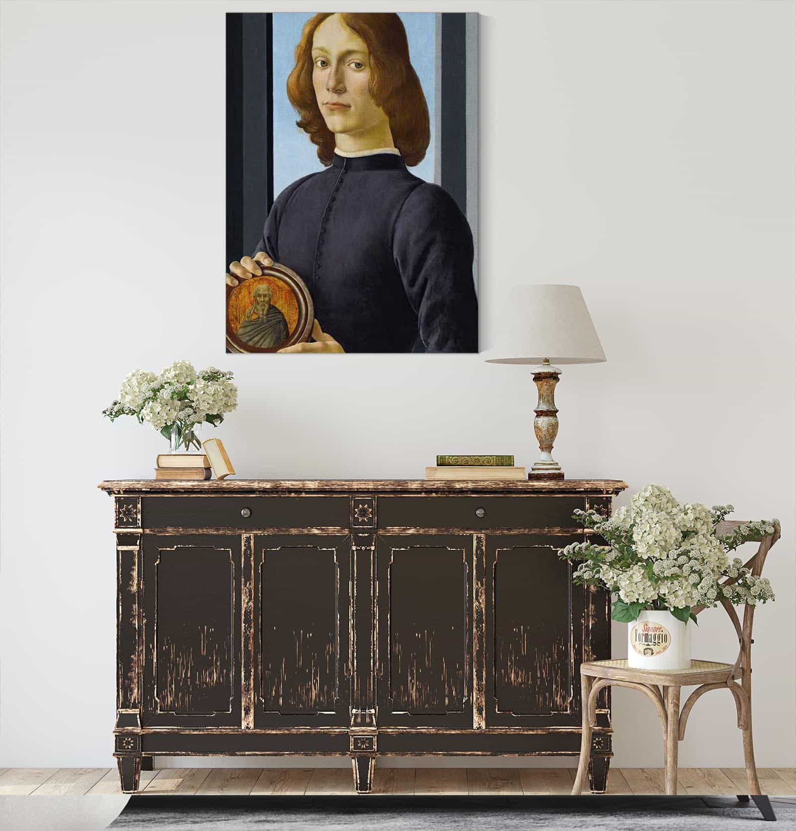 Portrait Of A Young Man Holding A Roundel by Sandro Botticelli